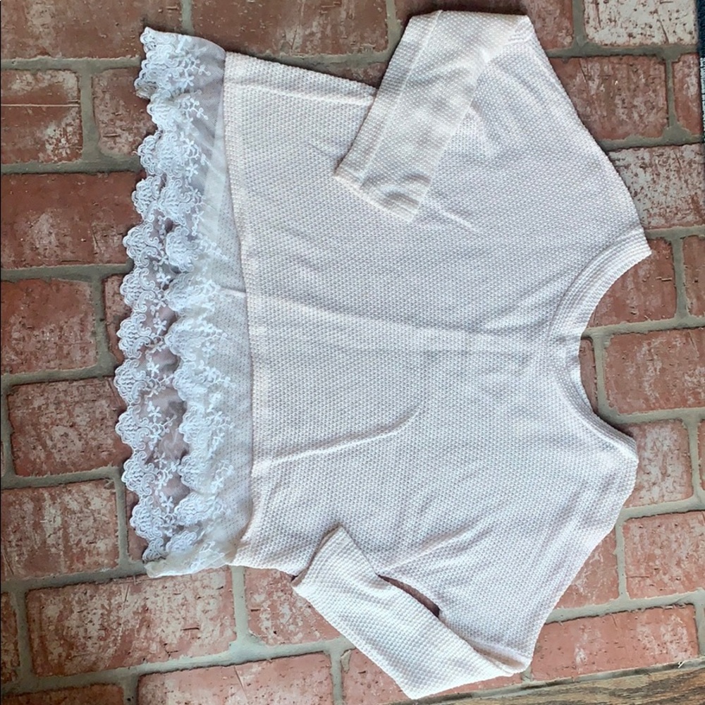 Cream long sleeve with a lace trim at the bottom